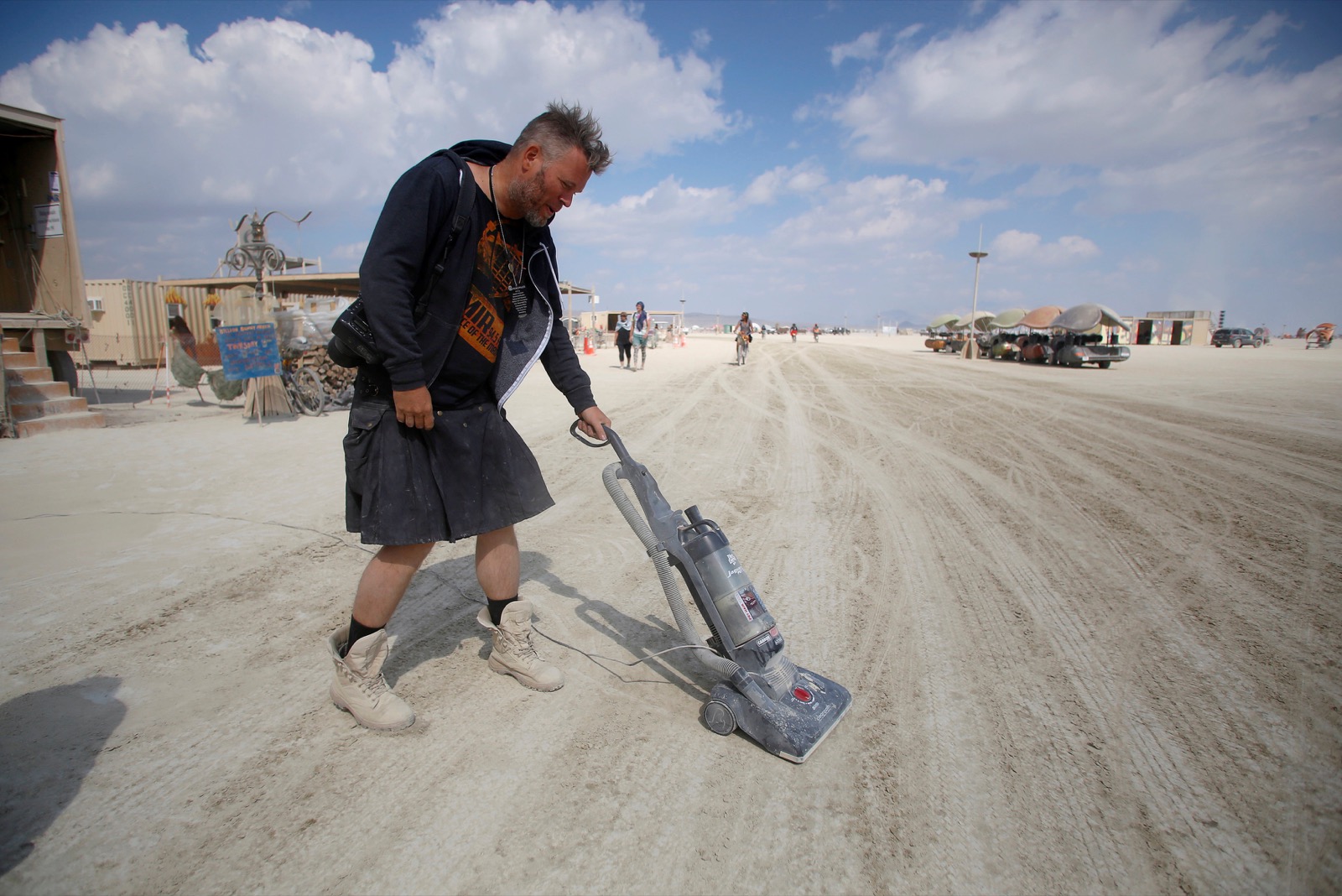 Huybert Van De Stadt vacuums the Playa as approximately 70,000 people from all over the world gathered for the 30th annual Burning Man arts and music festival in the Black Rock Desert of Nevada, U.S. September 4, 2016. REUTERS/Jim Urquhart FOR USE WITH BURNING MAN RELATED REPORTING ONLY. FOR EDITORIAL USE ONLY. NOT FOR SALE FOR MARKETING OR ADVERTISING CAMPAIGNS. NO THIRD PARTY SALES. NOT FOR USE BY REUTERS THIRD PARTY DISTRIBUTORS